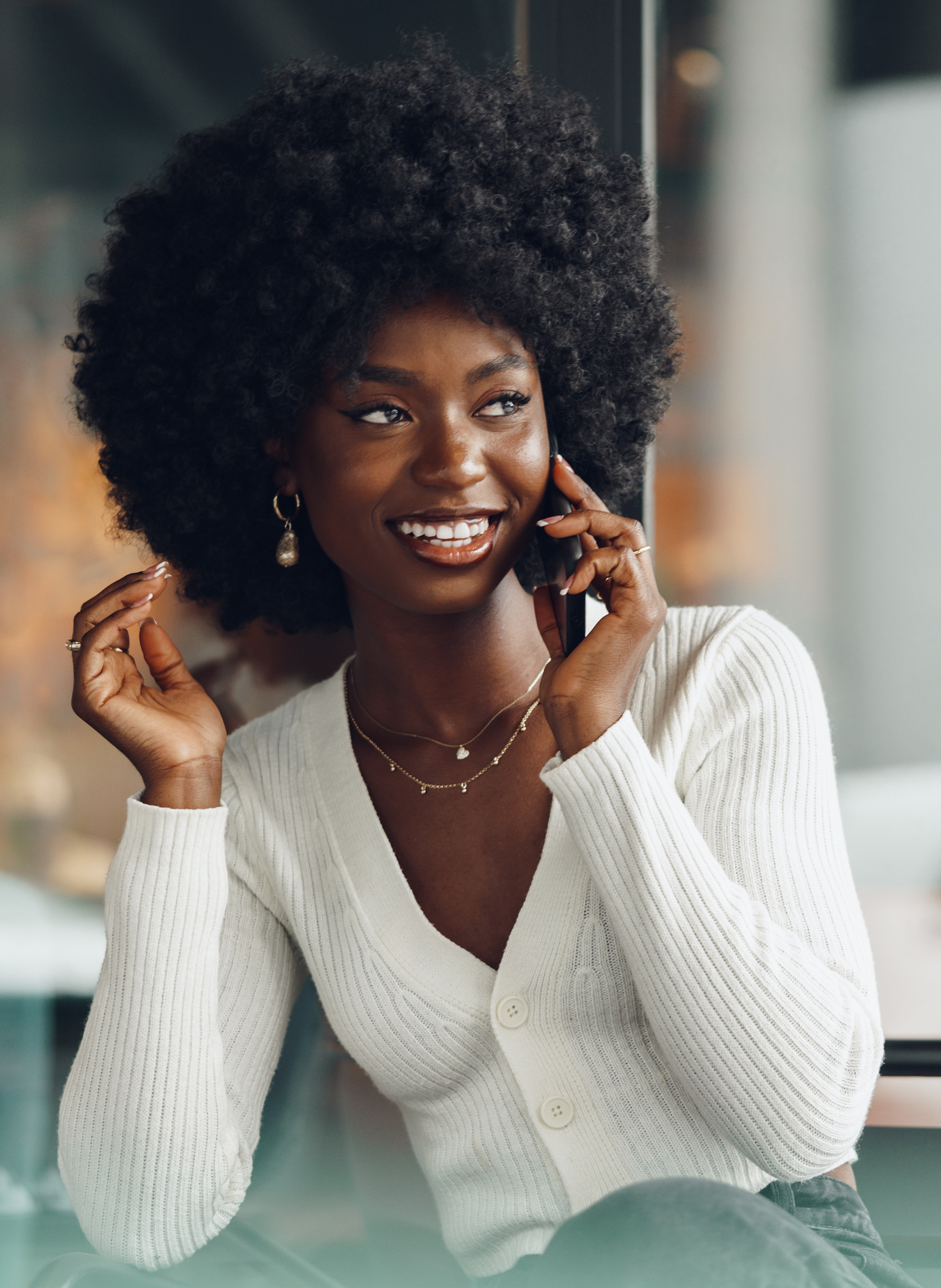 Smiling Young African Woman Talking on Cellphone